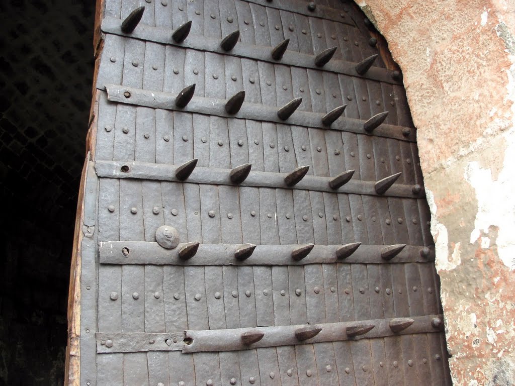 Daulatabad Fort gate. The spikes are to prevent elephant charges. by Derek Emson