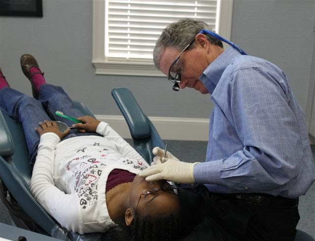 Warner robins orthodontist examining a patient by Pool Ortho