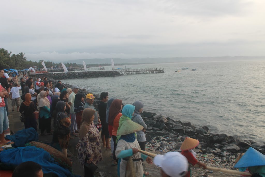 Fishermen dry the salty fish at Pantai Timur, Pangandaran, West Java, Indonesia by adrian_rusana