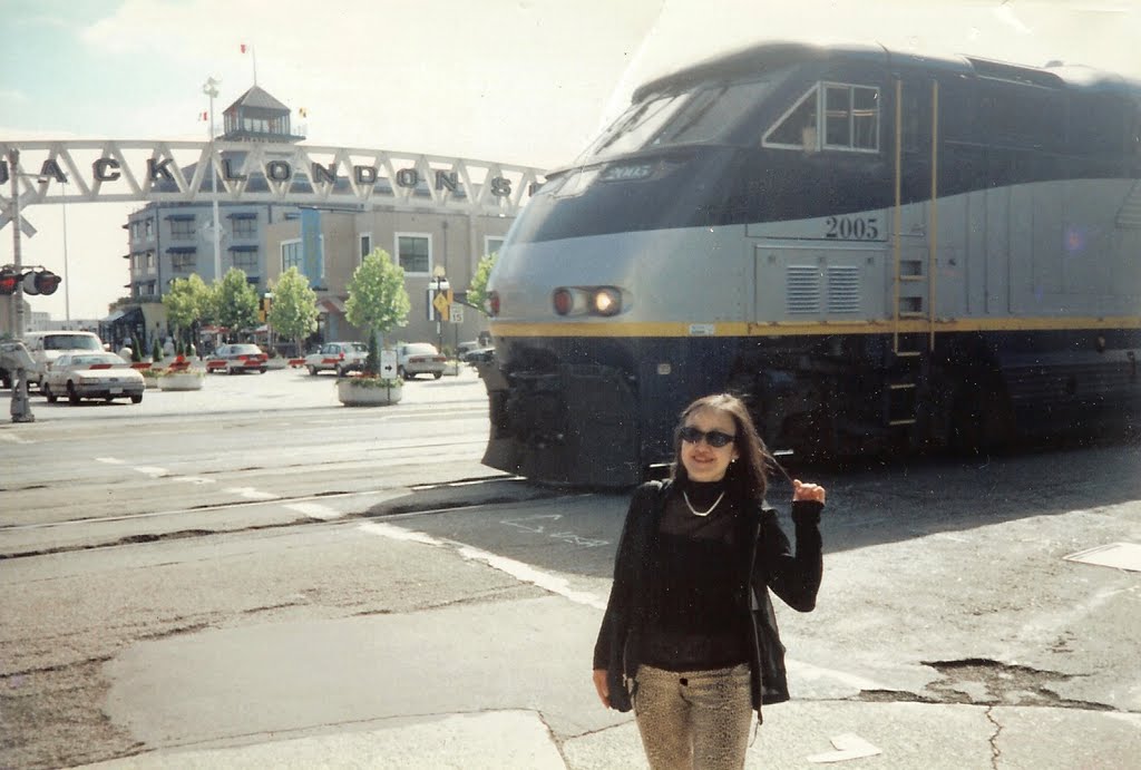 "The train is passing through the street! Welcome to Jack London Square in Oakland!" by Mimi1021