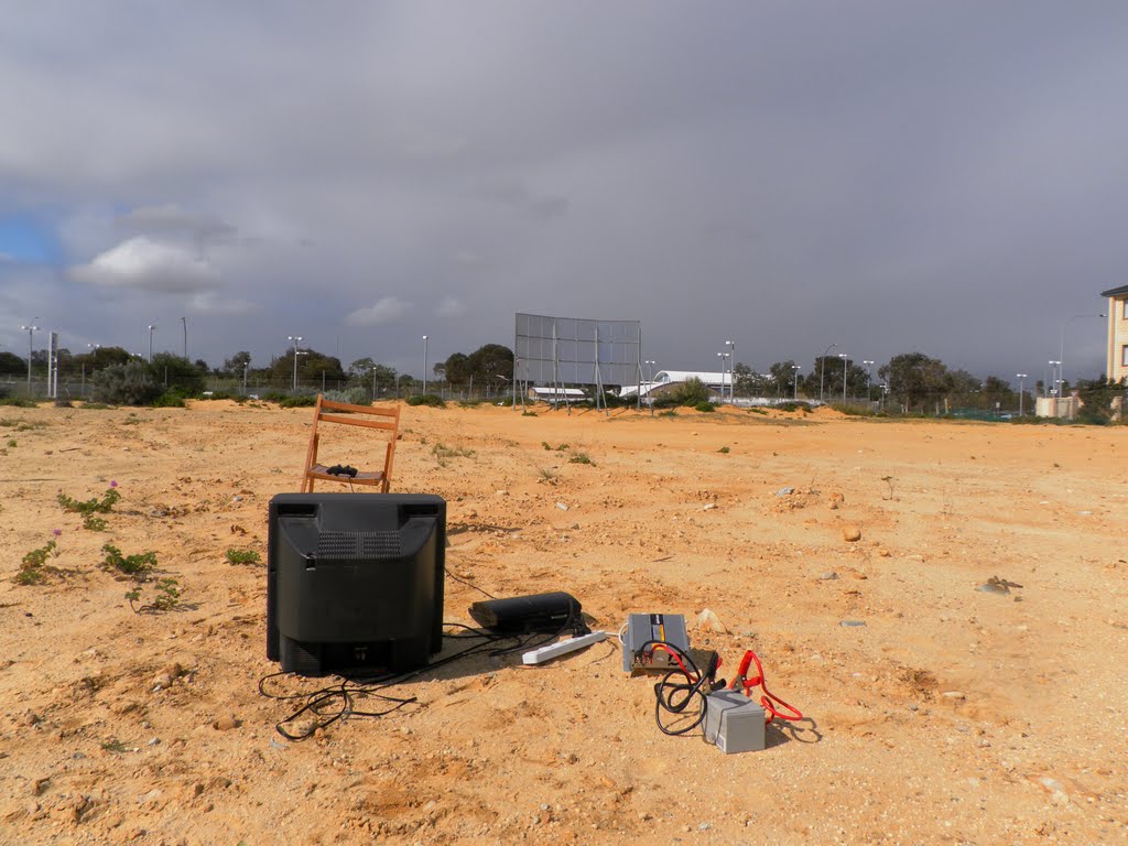 A television rigged to play video games in a vacant lot by Dylan Hewson