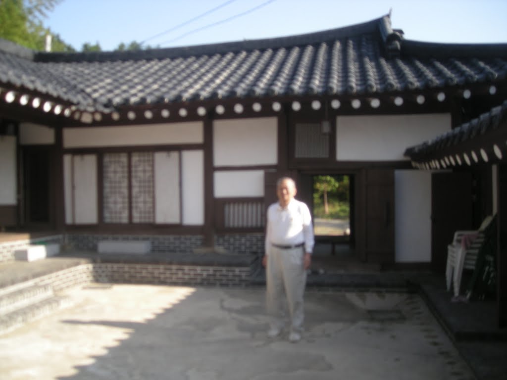 In Dong Park standing in the court yard of his country home in Yangyang by retrospro