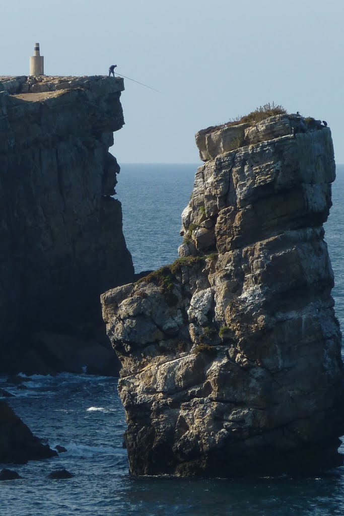 Fisherman high on rock in Peniche by fvnh