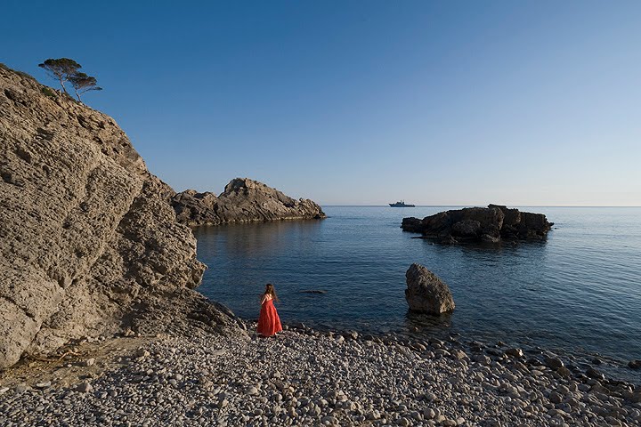 Girl in Red on the beach by Bernd Blomenroehr