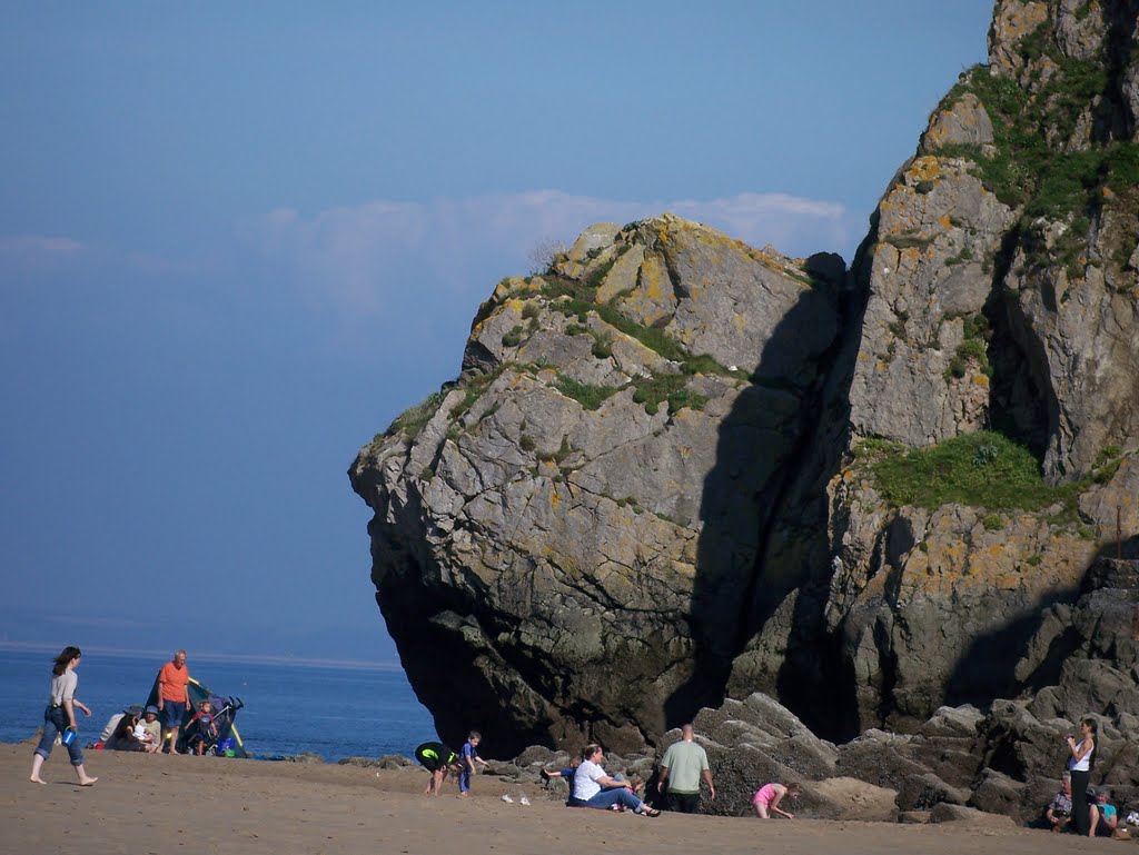 The face in the rock at Tenby South beach by edgar john