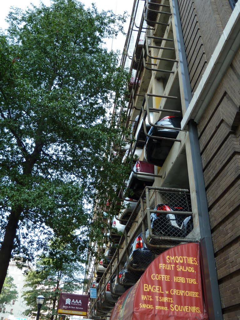 Rows of the back ends of cars, overhanging the sidewalk slightly from a parking deck along Marietta Street Northwest in downtown Atlanta, 8-17-11 by tompope2001