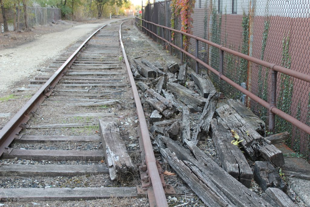 Railroad ties piled up next to the tracks by epodewell