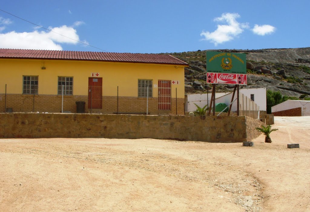 Promary school building on left of sign by Charles Vrey