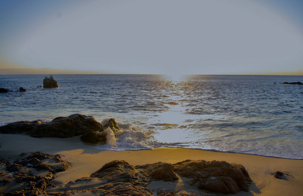 Morning sun on a rocky shore by John Greaves