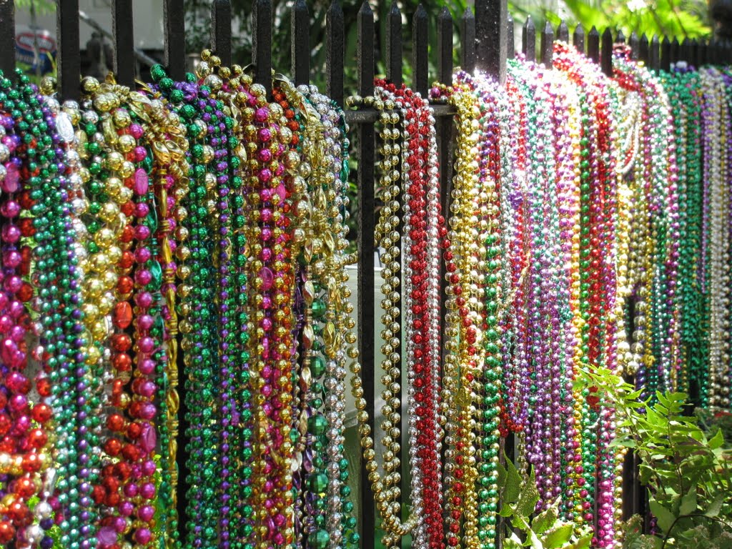 Mardi Gras beads on a fence by Ronald Losure