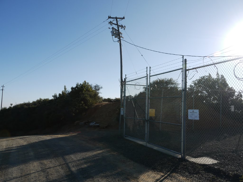 Bent power pole along the mountain ridge. by VasMan