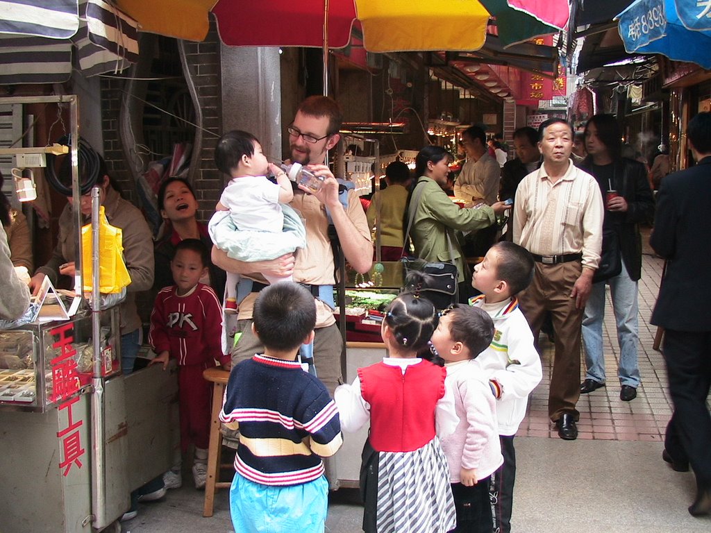 Kids Watching Baby Being Fed in the Jade Market by Firewall