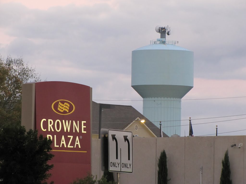 Crowne Plaza (sign) and water tower in background by WOLFGANG HOUSTON WEST