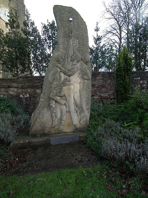 Shrove Tuesday Ball Game monument outside church wall. by Taraven