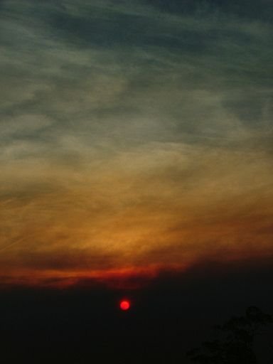 Sunset through smoke plume by Greg Steenbeeke