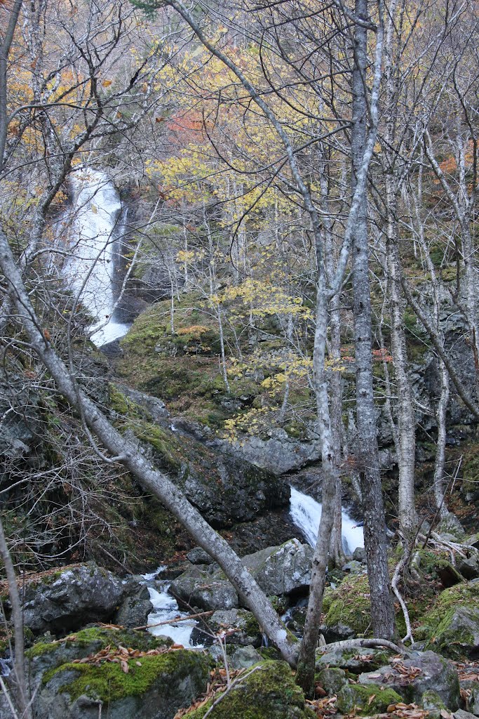 Uisage Ban Falls Provincial Park New Glen, NS The name Uisage Ban comes from the Gaelic meaning “white water”. The park is located near New Glen, Victoria County (Hwy 105, Exit 9) . A four km (2.4 mi.) trail through a climax hardwood forest, provides access to view the 16 m (50 ft.) high waterfall. The walls of the gorge tower 50 m (500 ft.) on either side of the falls. by Ken Heaton