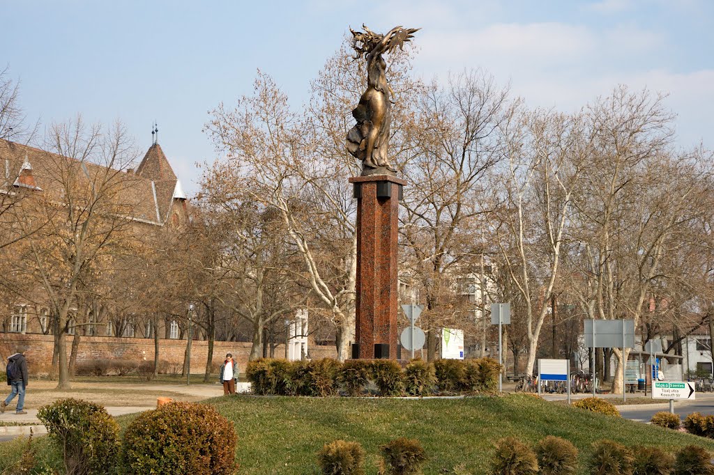 Hódmezővásárhely, Hungary – Asztrológia szobor (Astrology Sculpture). Máté István és Lantos Györgyi Asztrológia címet viselő szobra került 2011-ben a körforgalom közepére. Hódmezővásárhelyen követendő szép példa a kialakított körforgalmak szoborral való díszítése. A fiatal, kecses nőalak magas, gránittal borított posztamensen áll. Jobb kezében a Napot, bal kezében a növő Holdat tartja, hosszú hajában az égbolt csillagai fénylenek. by Gausss