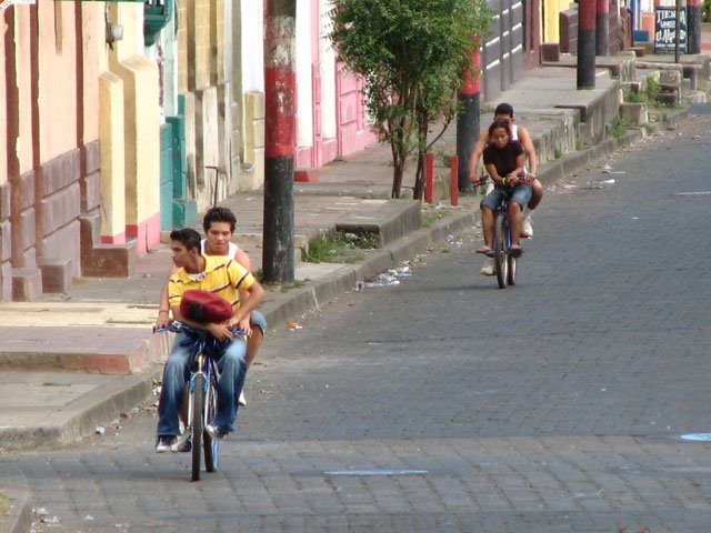 Cyclists doubling on their bikes, toasty afternoon in Leon Nicaragua by snorth