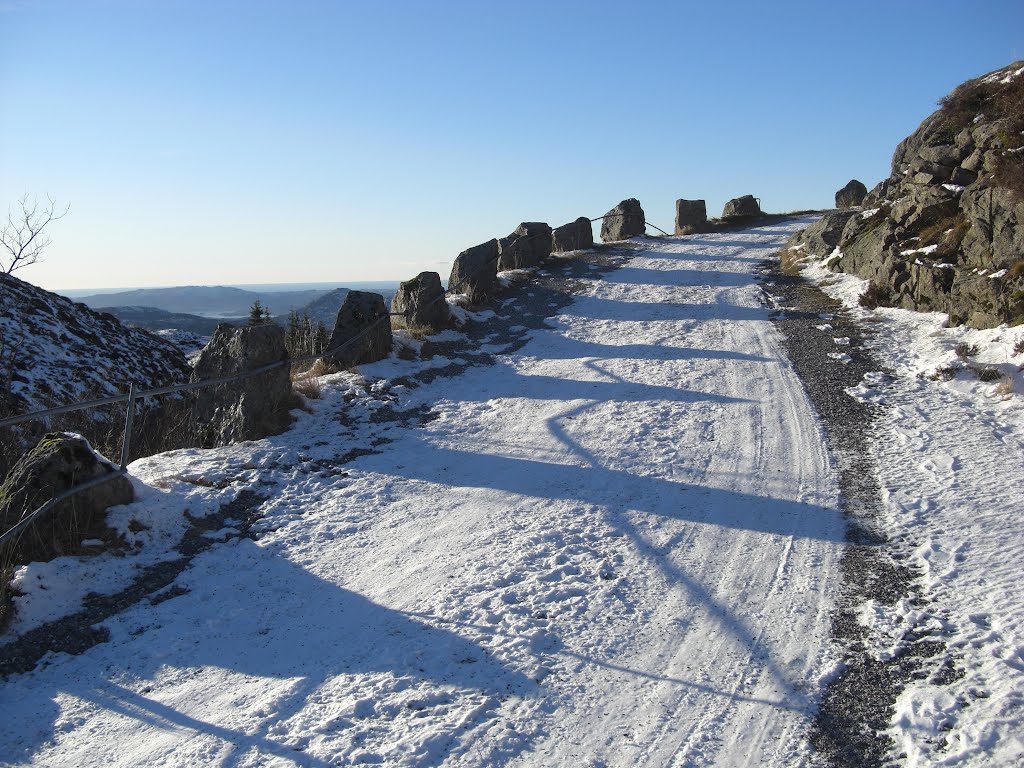 Beautiful shadows of the rocky fence a sunny and snowy day in november by Mona Lygre