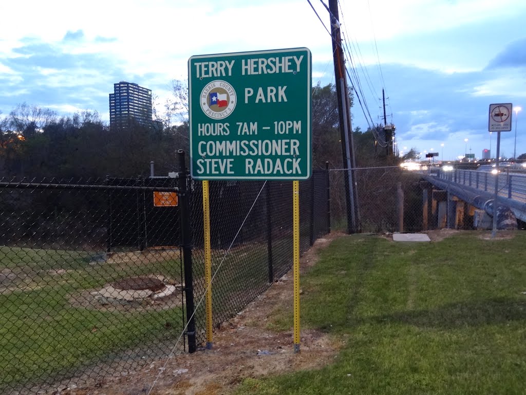 Terry Hershey Park Sign at I-10 Frontage Road (inbound) with BP Tower in background by WOLFGANG HOUSTON WEST