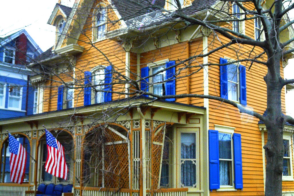 House yellow/orange with blue shutters Cape May NJ by Geraldine Clark