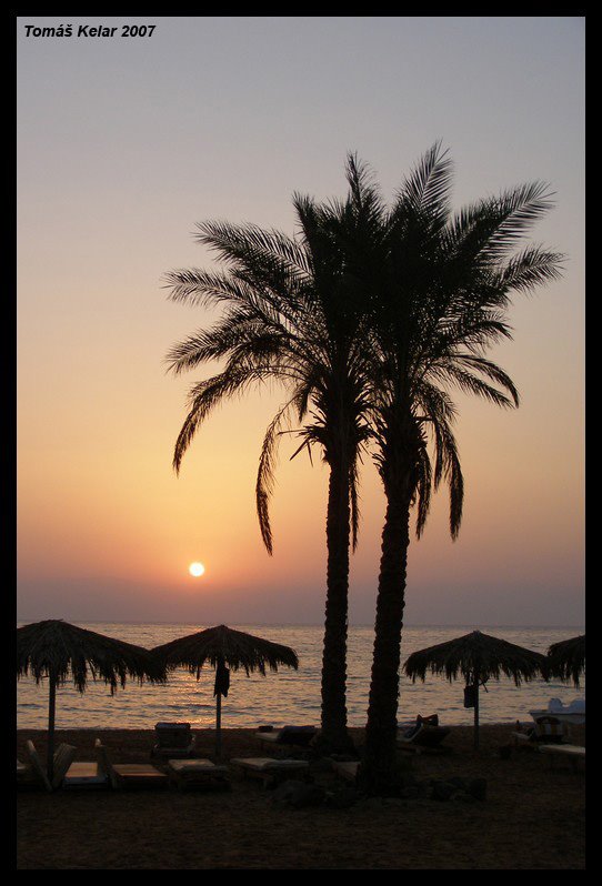 Sunrise on a beach by Tomas Kelar