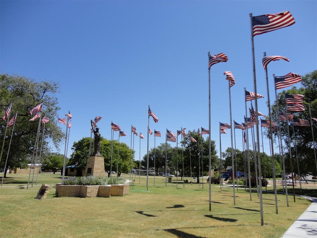 Flags flying around Statue of Liberty reproduction, Lacrosse, KS by marnox1