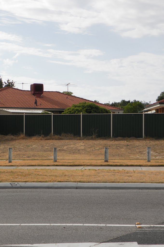 Bollards and green fencing by Dylan Hewson