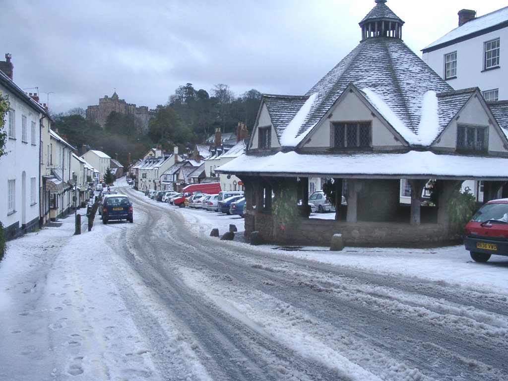 Dunster - High Street, Yarn Market & Castle in the snow by John S Bacon