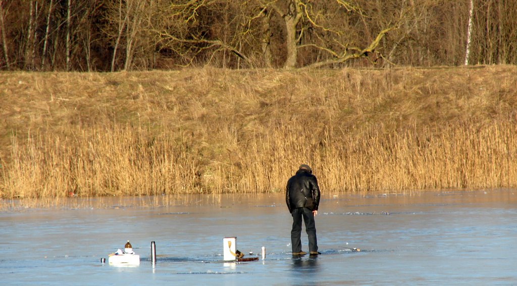 Fisherman during the winter over Pilaite dam ice by Rimgaudas Bernotas