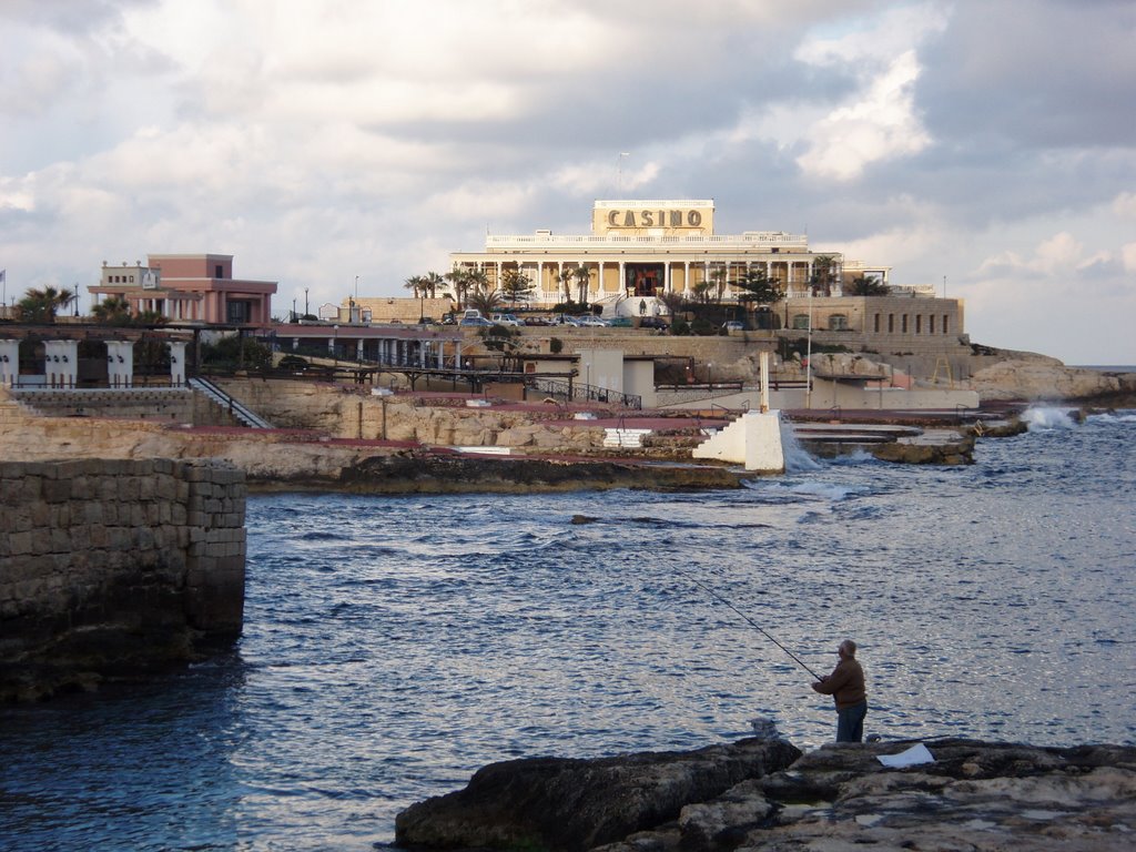 Fisherman with Malta Casino in background, Malta by Sonya Brunt