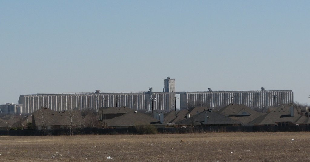 Grain Silos in Sagianw Texas Loom Over the Rooftops by GregFW