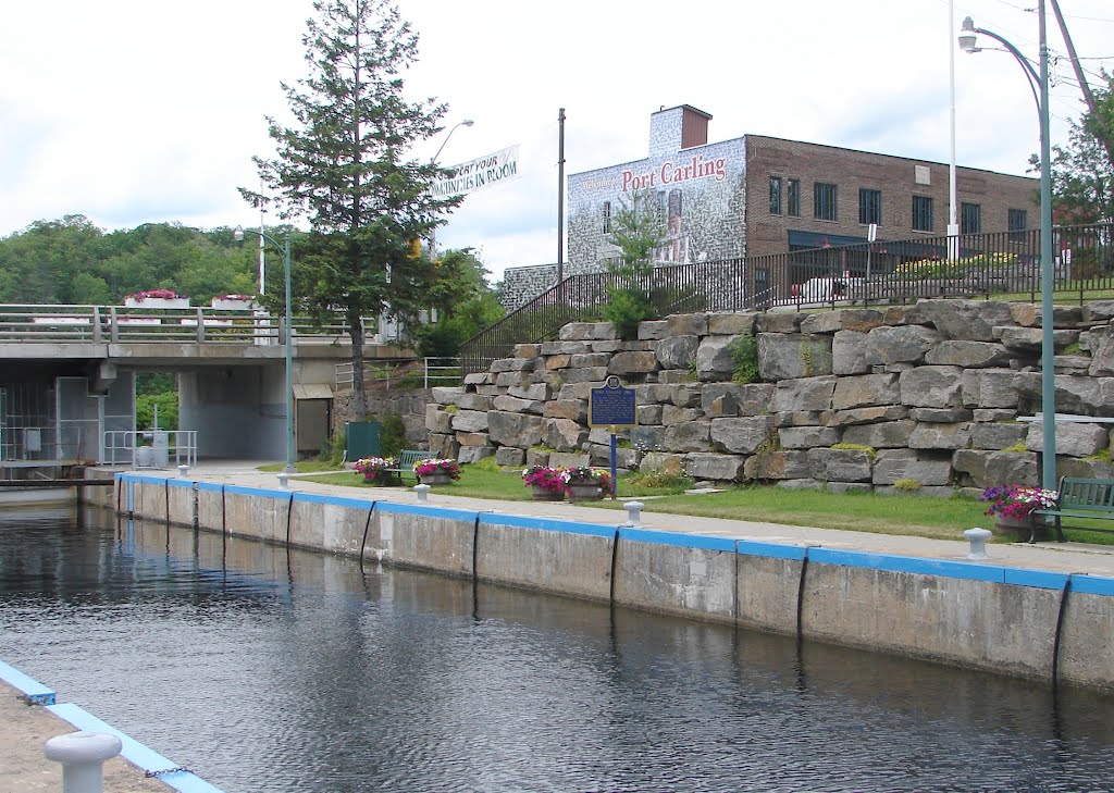 Port Carling Lock with Stone Wall & Photographic Wall on Building, Muskoka Lakes, Canada by Joseph Hollick