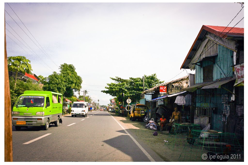 Green Jeep at the highway by ipe eguia