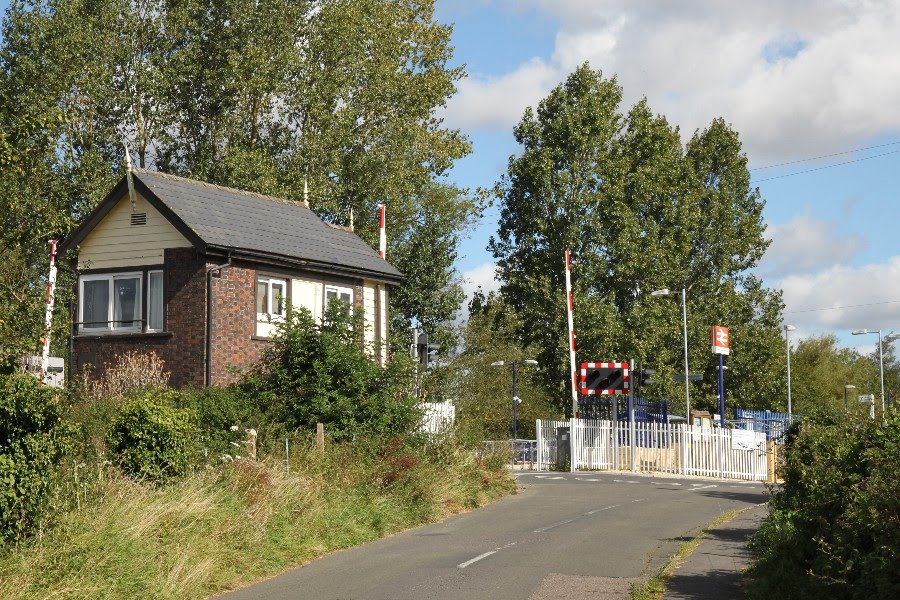 The station and level crossing at Ascott-under-wychwood, Oxfordshire by Roger Sweet