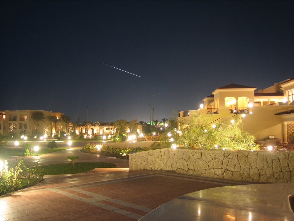 Plane in the sky at night's Jaz Mirabel Beach by Mikkey