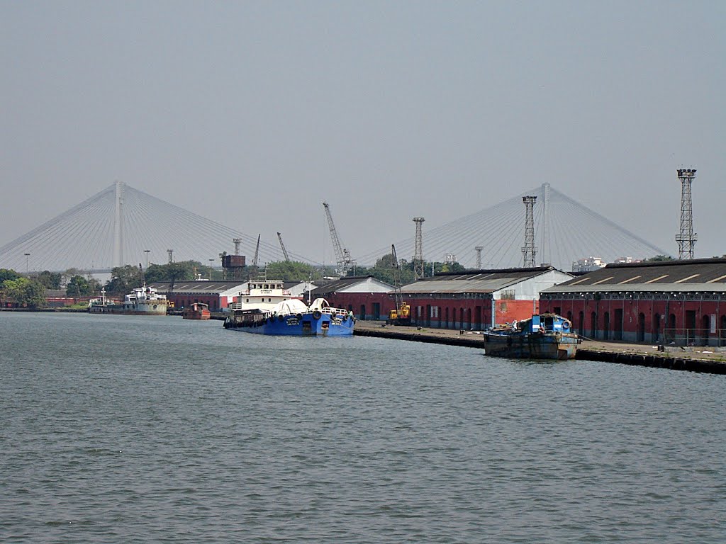 Kidderpore Docks with the suspension bridge across river Hoogly in the background, Kolkata, West Bengal, India by mcmurali