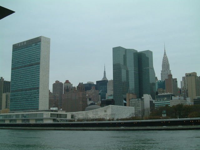 New York - UN Building with Chrysler Building in background by Ken & Janie Rowell