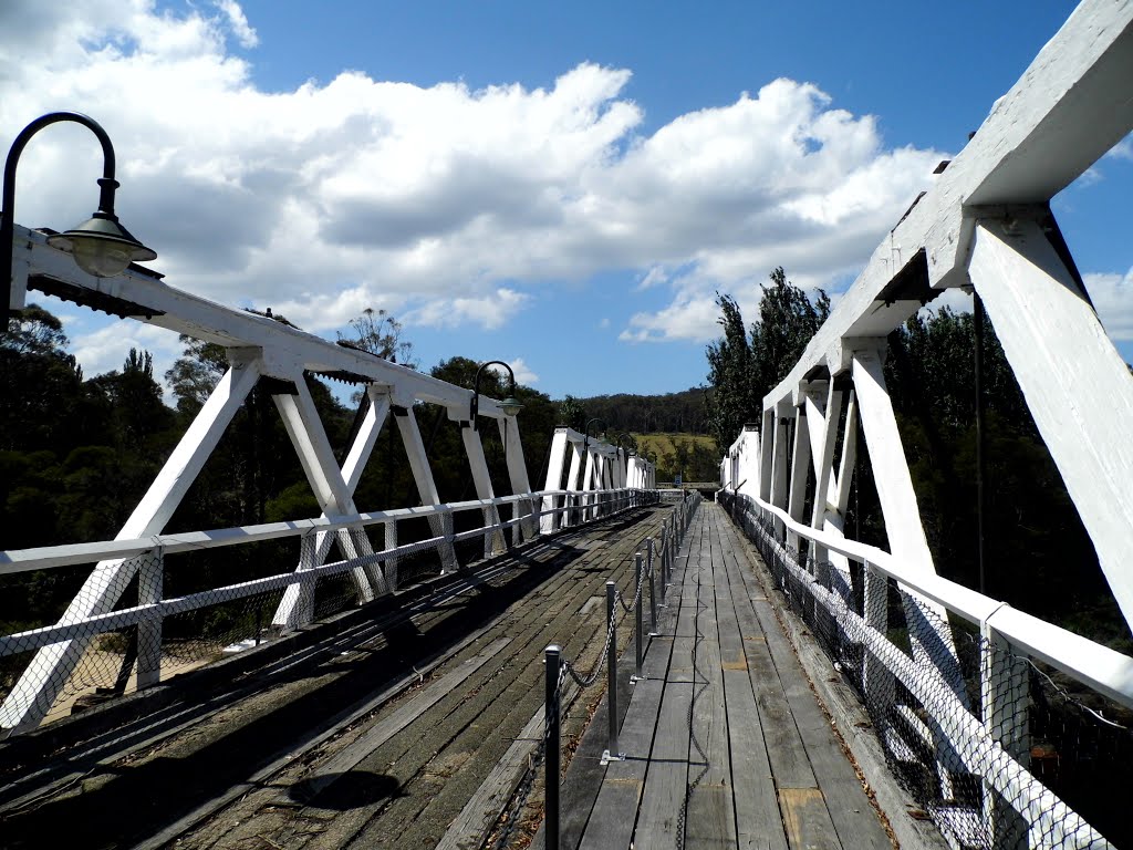 Genoa Heritage Bridge is the second parallel truss girder to be built over the Genoa River. The first, opened in 1916 by Mrs. Alexander, was constructed entirely of wooden piles. The structure failed to withstand the 1919 floods and collapsed. However by 1928 the present bridge had been opened, this time reinforced concrete piers, founded on concrete cylinders were used to support the structure [2012] by XpektTom