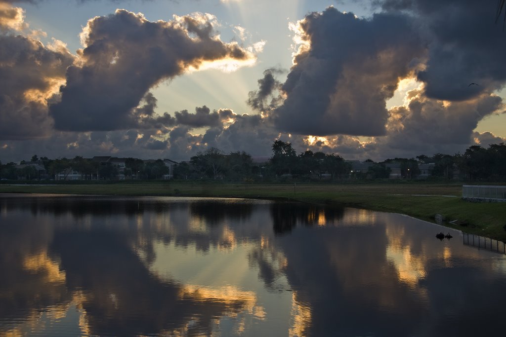 Houses near a reflecting lake a sunrise by Phil Comeau