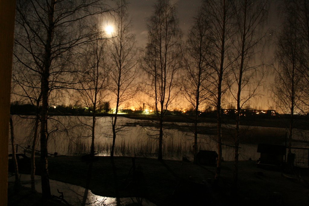 Moon and lights over ice by ainars brūvelis