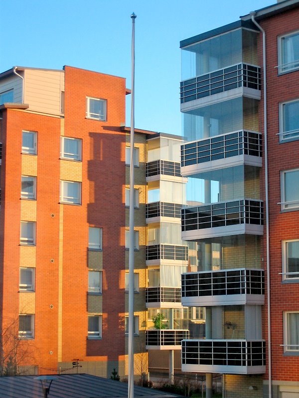 Apartment buildings at sunset by Juho Ruohola