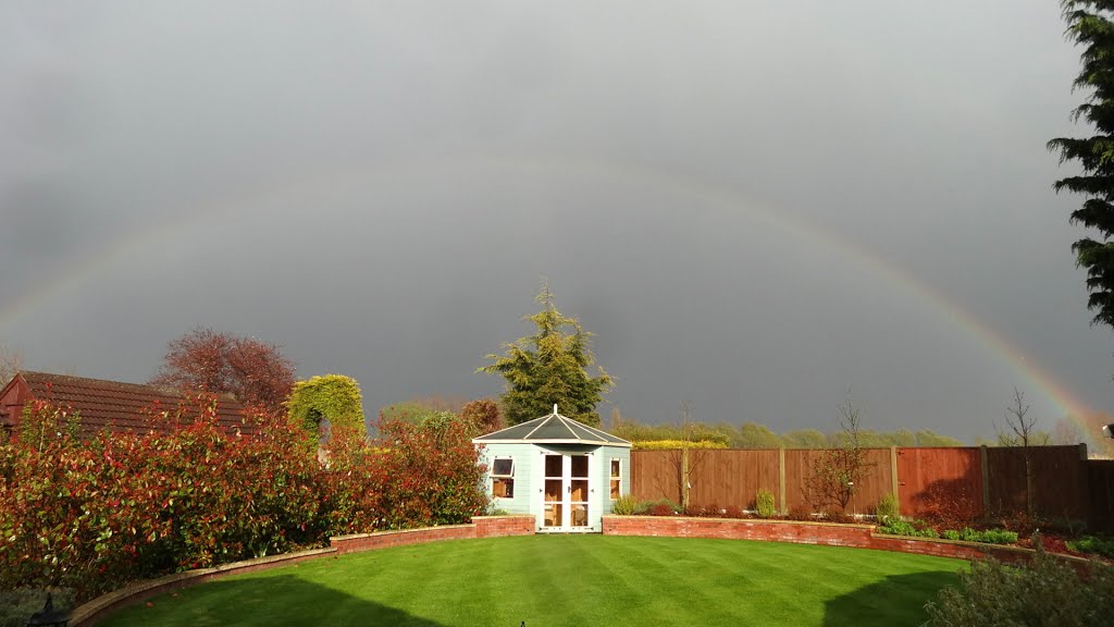 Bright sunshine and a heavy spring shower result in a spectacular complete rainbow over my garden by MDSouter