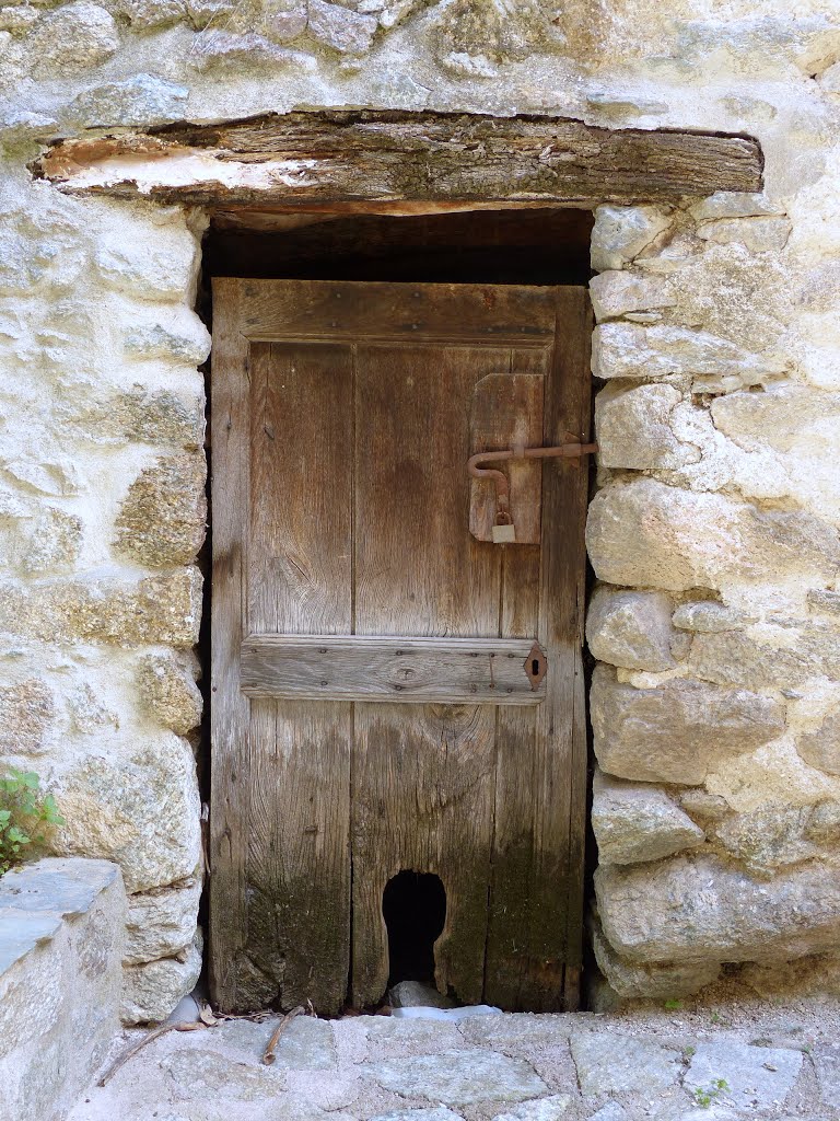 Door with cathole. Lama, Corsica by Helvi H.