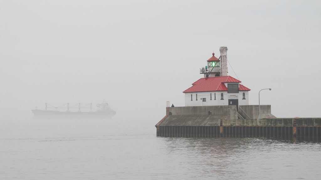 Oct 2012 - Duluth, Minnesota. Ship in the fog at the Duluth Harbor South Breakwater Outer Lighthouse. by BRIAN ZINNEL