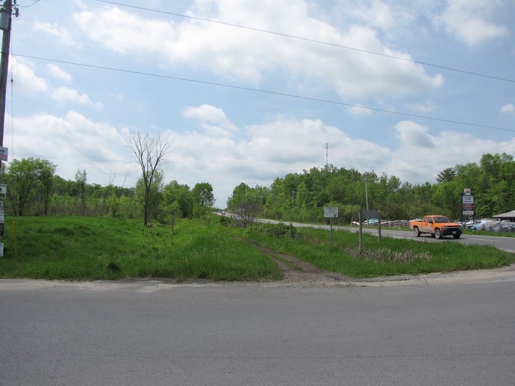 Location of the original Godfrey train station on the Kingston & Pembroke Railway, built in 1875, last used in 1960. The original post office was 150 m. south of here, and was called the Deniston P.O.. Chester Godfrey lived across the road on the right, in 1878. Highway # 38 was built in 1934 following the local township roads, and the Westport Road here was also here in 1878. That is the K&P trail just to the left of the orange truck, it uses the old K&P rail bed. by Steve Manders