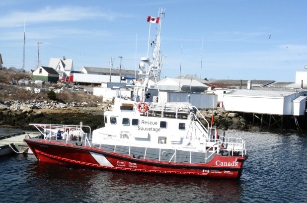 Sambro, Nova Scotia - A Canadian Coast Guard vessel stands by near the main wharf. by jonfromnsca