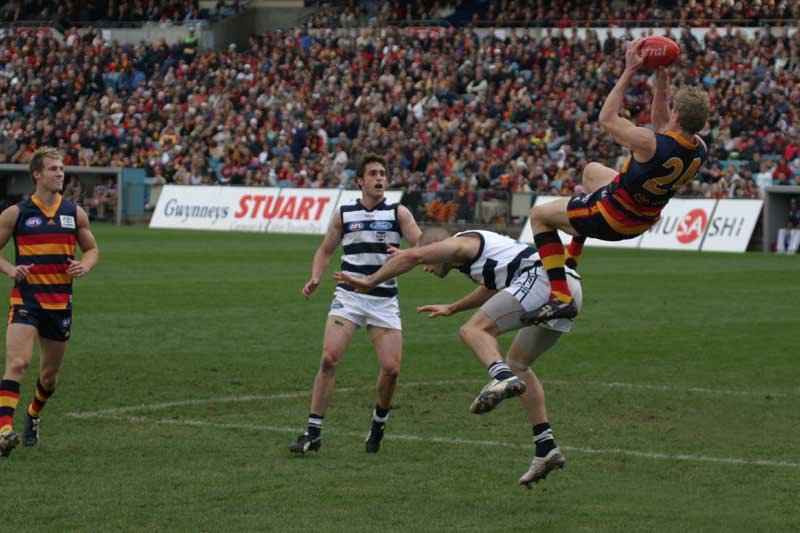 The Adelaide Crows' Brett Burton takes a screamer over a Geelong opponent in a match at Adelaide's Football Park. To see more AFL and other sport images, visit www.freewebs.com/philwillmedia by philwillmedia