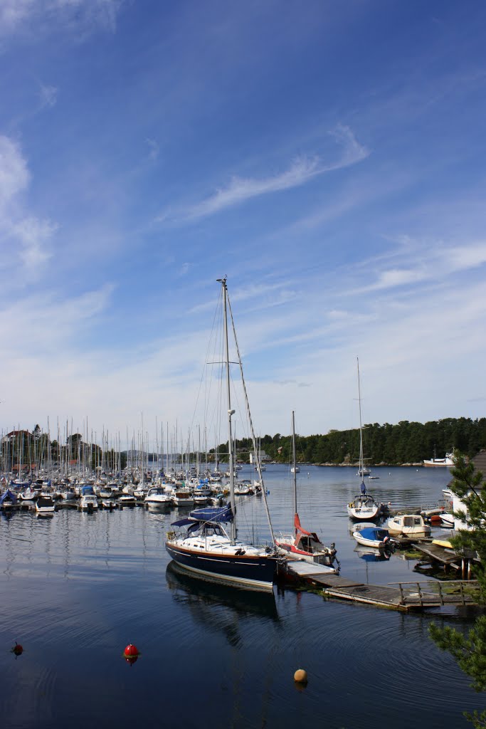 Blue sky, a blue sailboat and beautiful clouds by Mona Lygre