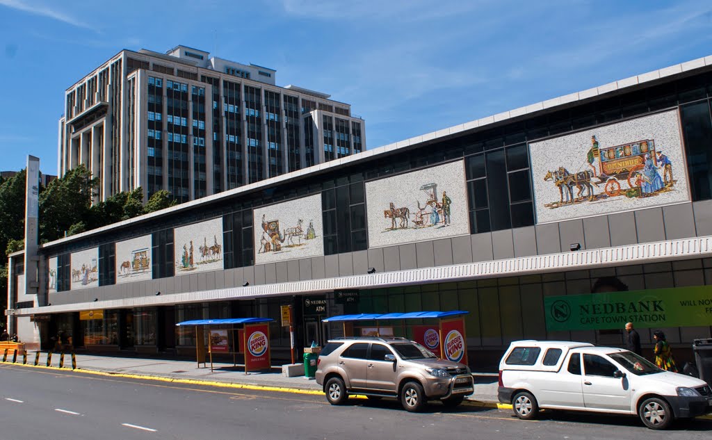 Cape Town Railway Station with mosaics on the wall, next to the Paul Sauer building. The architects for the Cape Town station were father and son Alexander Stewart Cruickshank & Ian Grant Stewart Cruickshank, together with the Railway Administration's in-house architect Janos Lenard. The mosaics are designed by Samuel Jozua (Sam) Fourie (1919-2012), artist in the designing section of the The South African Railways, with the help of Miss Hilary Coetzee. The builder was Dura. by Hans R van der Woude